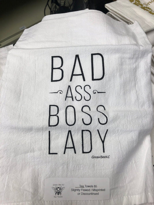 a white cotton kitchen towel with the words bad ass boss lady