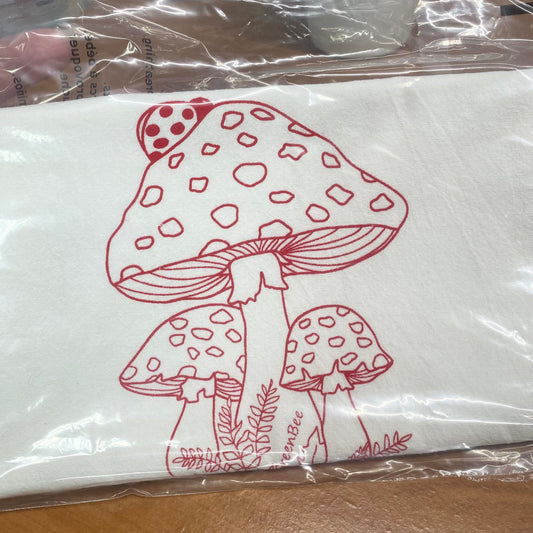 red mushroom on a white tea towel