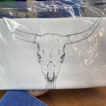 white cotton tea towel with a cow skull slightly flawed kitchen tea towel