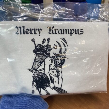 cotton tea towel with a vintage German Krampus that says merry cramps slightly flawed kitchen tea towel