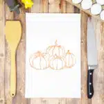 a bunch of pumpkins on a white towel