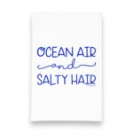 kitchen tea towel with blue lettering saying Ocean Air & Salty Hair kitchen tea towel