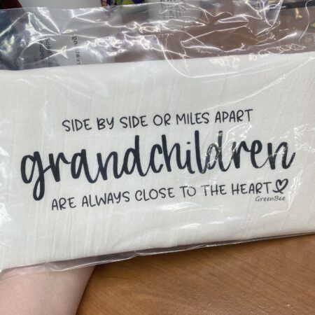 a kitchen towel that says side by side or miles apart grandchildren are always close to the heart